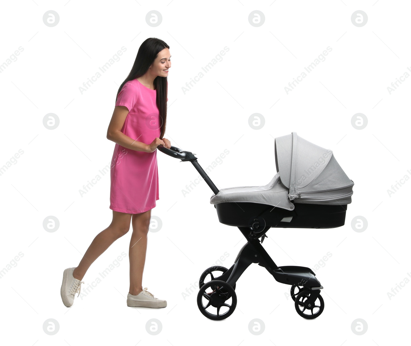 Photo of Happy young woman with baby stroller on white background