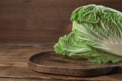 Photo of Fresh ripe Chinese cabbage on wooden table. Space for text