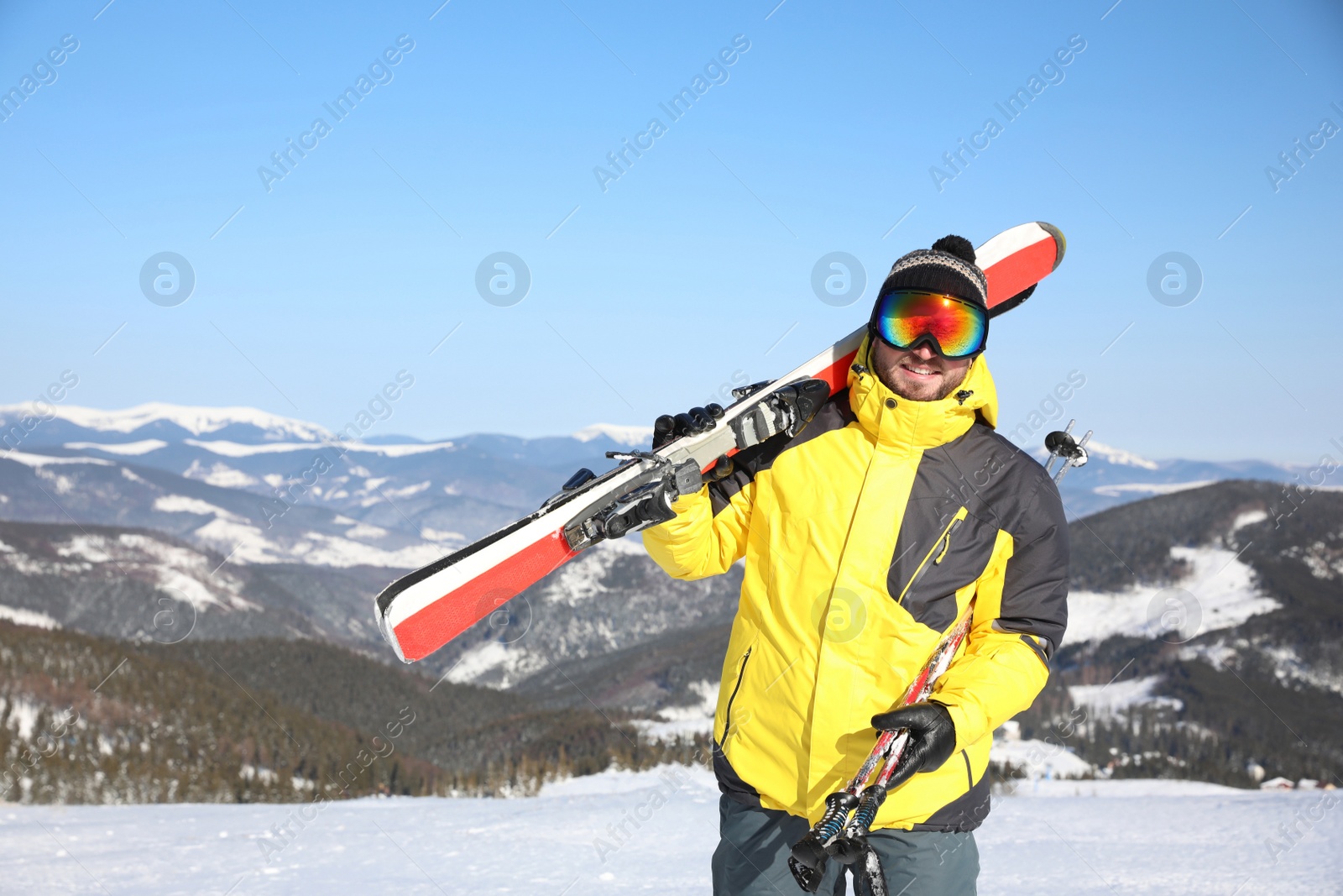 Photo of Young man with ski on hill. Winter vacation