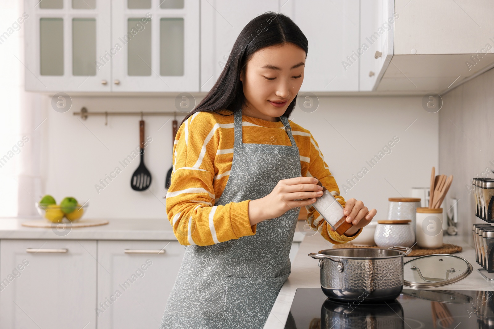 Photo of Beautiful woman cooking in kitchen. Space for text