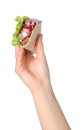 Photo of Woman holding delicious taco with meat and vegetables on white background, closeup