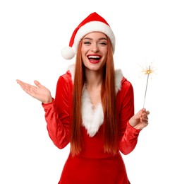 Young woman in red dress and Santa hat with burning sparkler on white background. Christmas celebration