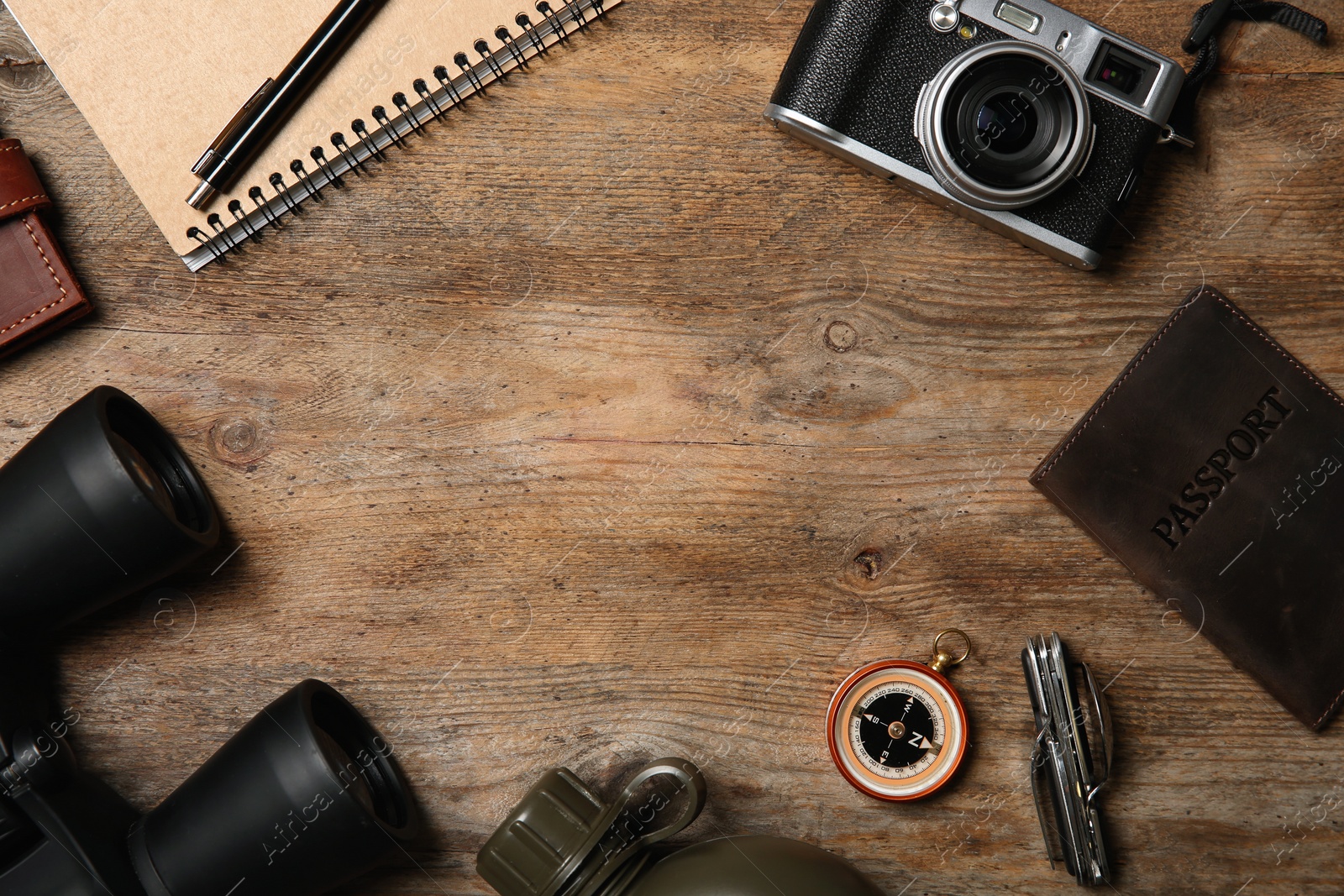 Photo of Flat lay composition with camping equipment on wooden background. Space for text