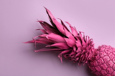 Photo of Pink pineapple on light background, top view. Creative concept