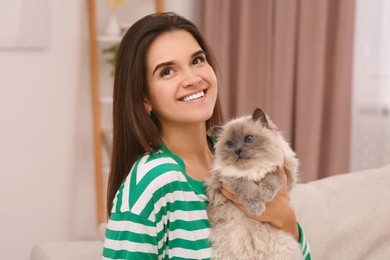 Happy woman with her cute cat at home