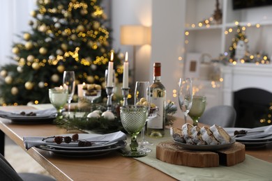 Christmas table setting with festive decor and dishware in living room