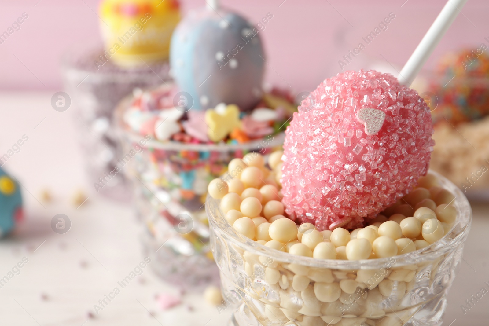 Photo of Egg shaped cake pop on table, closeup with space for text. Easter celebration