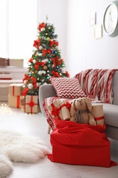Room interior with Christmas tree and Santa's bag of gifts