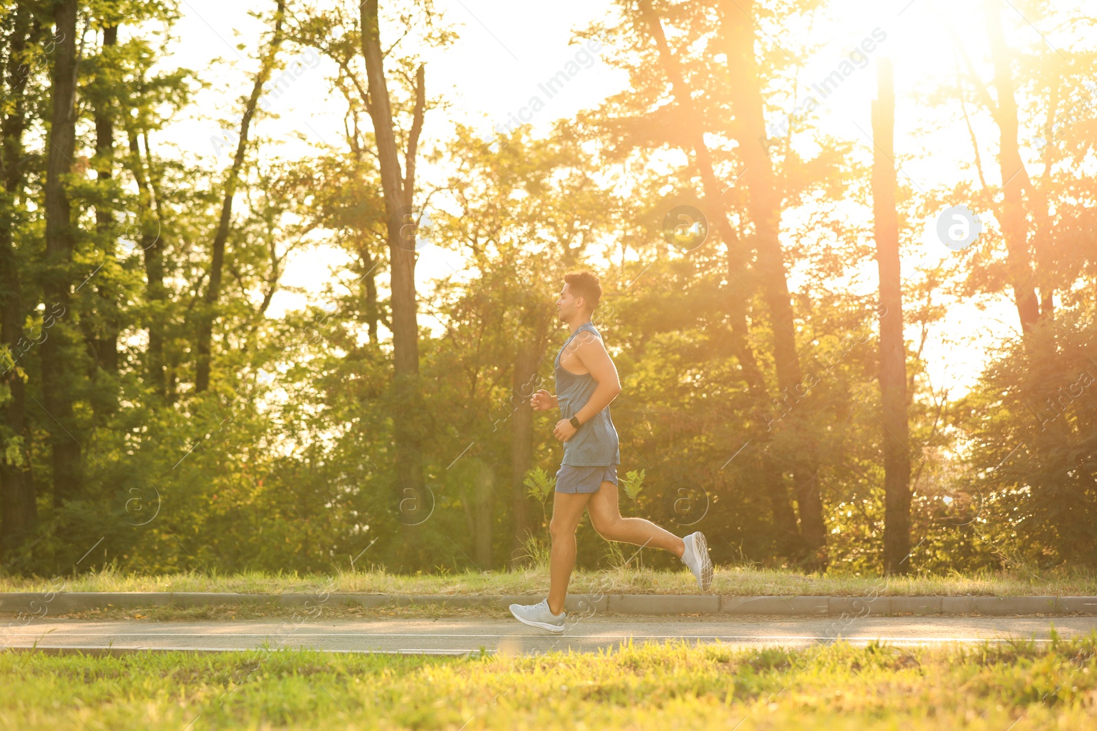 Photo of Young man running in park on sunny day