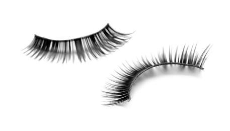 Beautiful pair of false eyelashes on white background