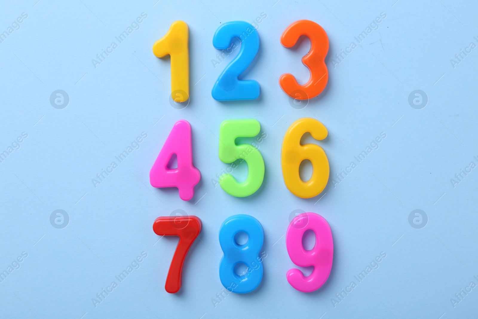 Photo of Colorful numbers on blue background, flat lay