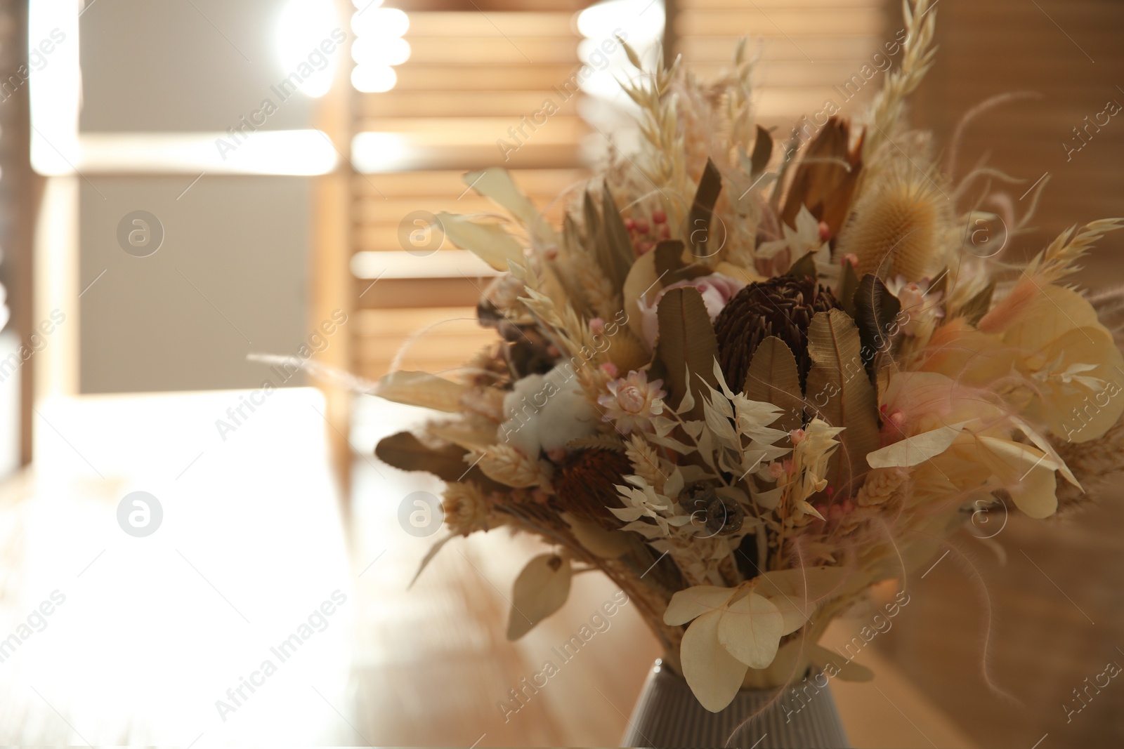 Photo of Beautiful bouquet of dry flowers in vase indoors. Space for text