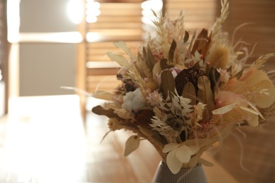 Beautiful bouquet of dry flowers in vase indoors. Space for text