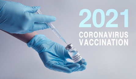 Doctor filling syringe with coronavirus vaccine on light grey background, closeup 