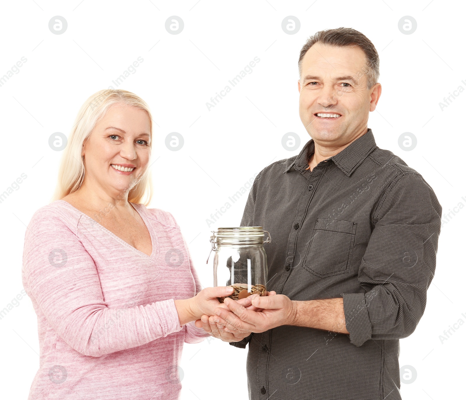 Photo of Happy senior man and his wife holding jar with coins on white background