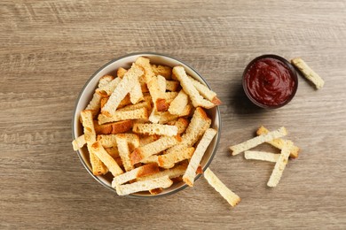 Delicious hard chucks with ketchup on wooden table, flat lay