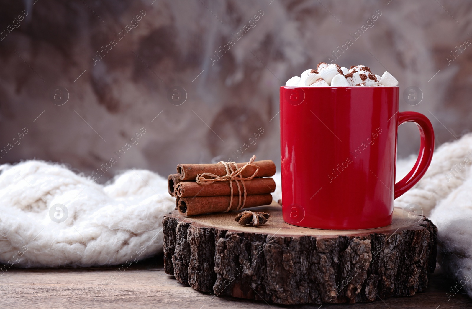 Photo of Composition of tasty cocoa with marshmallows in cup on wooden table. Space for text