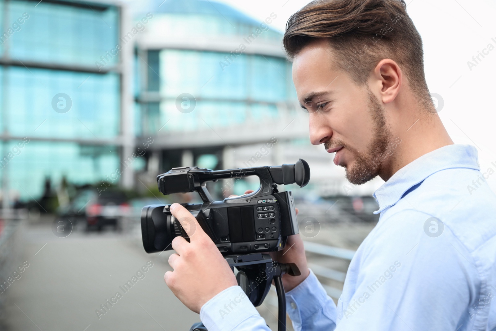 Photo of Video operator with camera working on city street