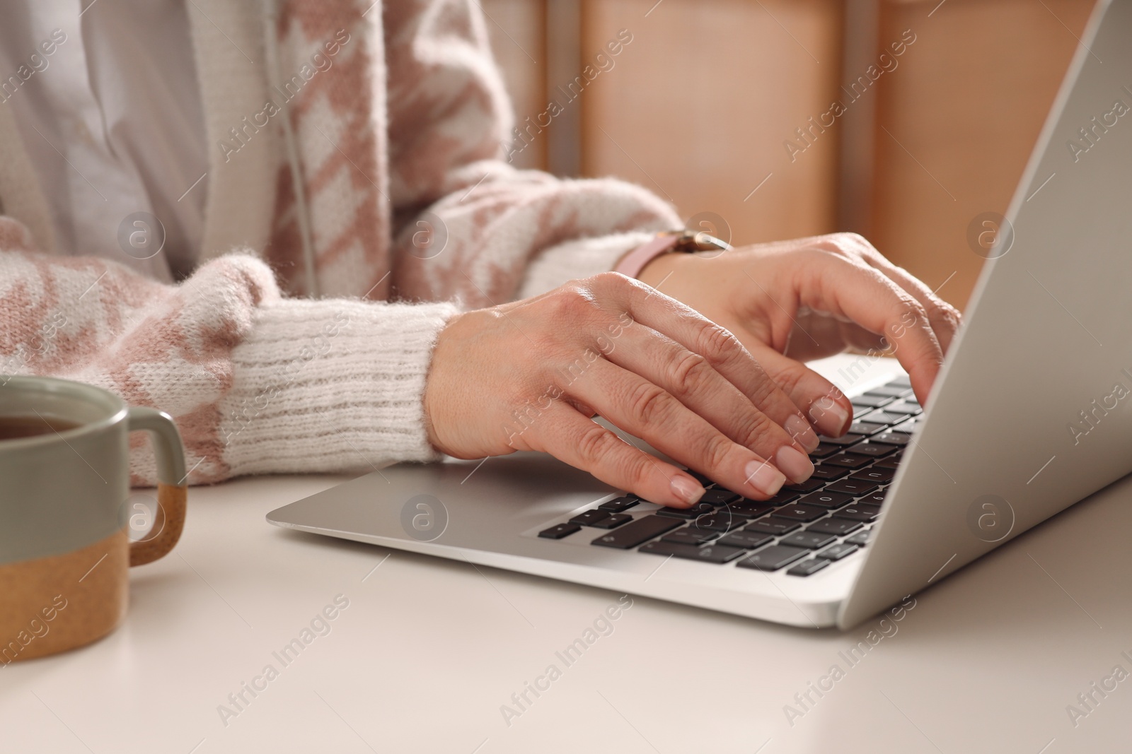 Photo of Woman with modern laptop learning at table indoors, closeup