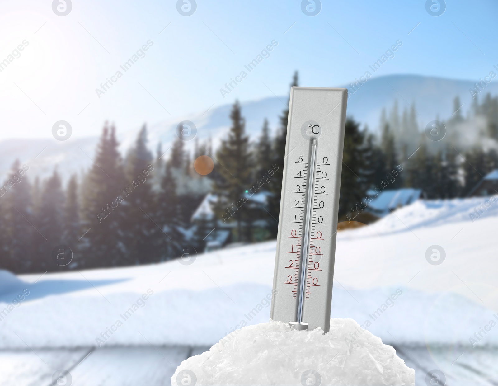 Image of Thermometer in snow showing temperature below zero outdoors on winter day