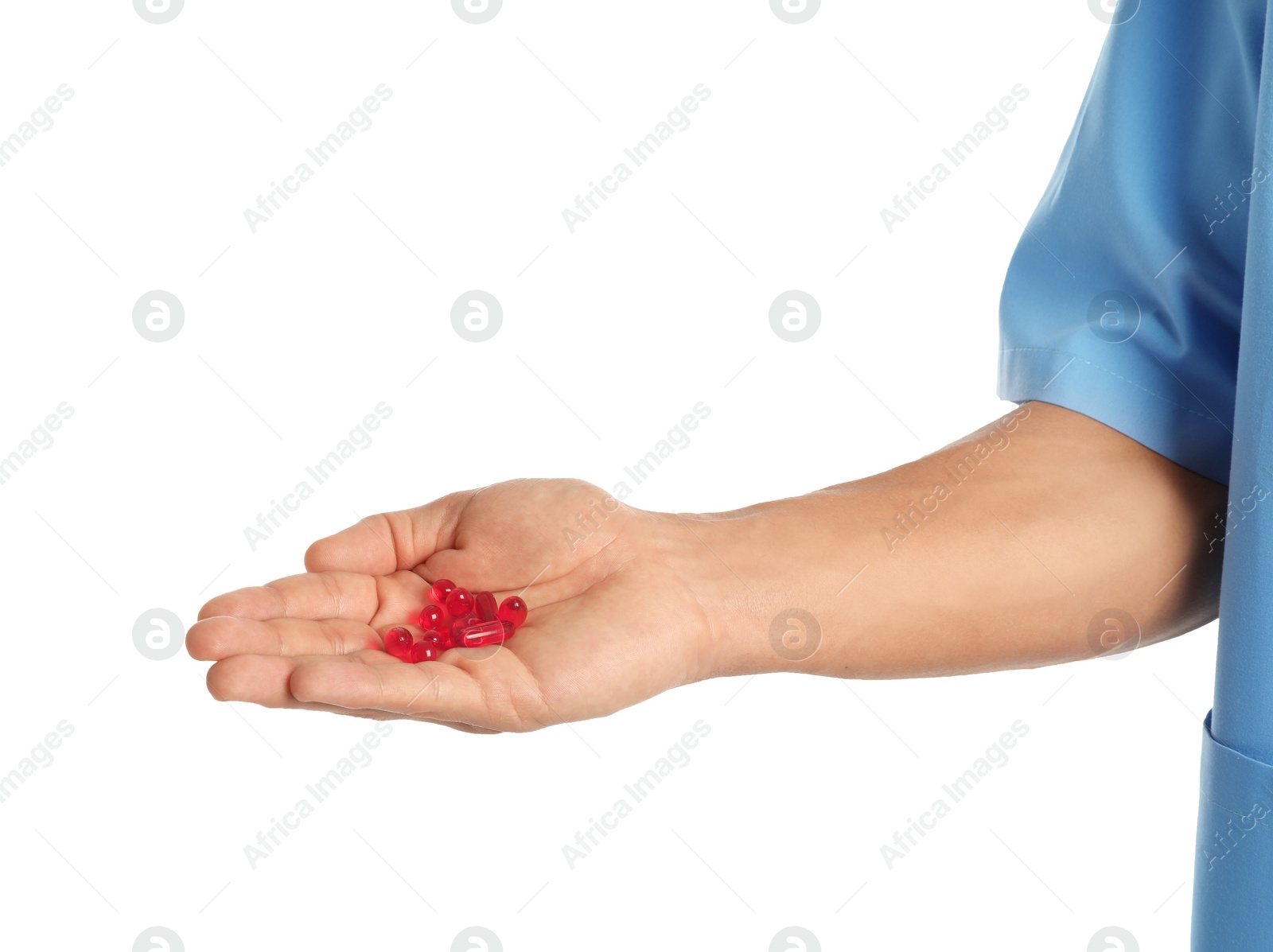 Photo of Male doctor holding pills on white background, closeup. Medical object