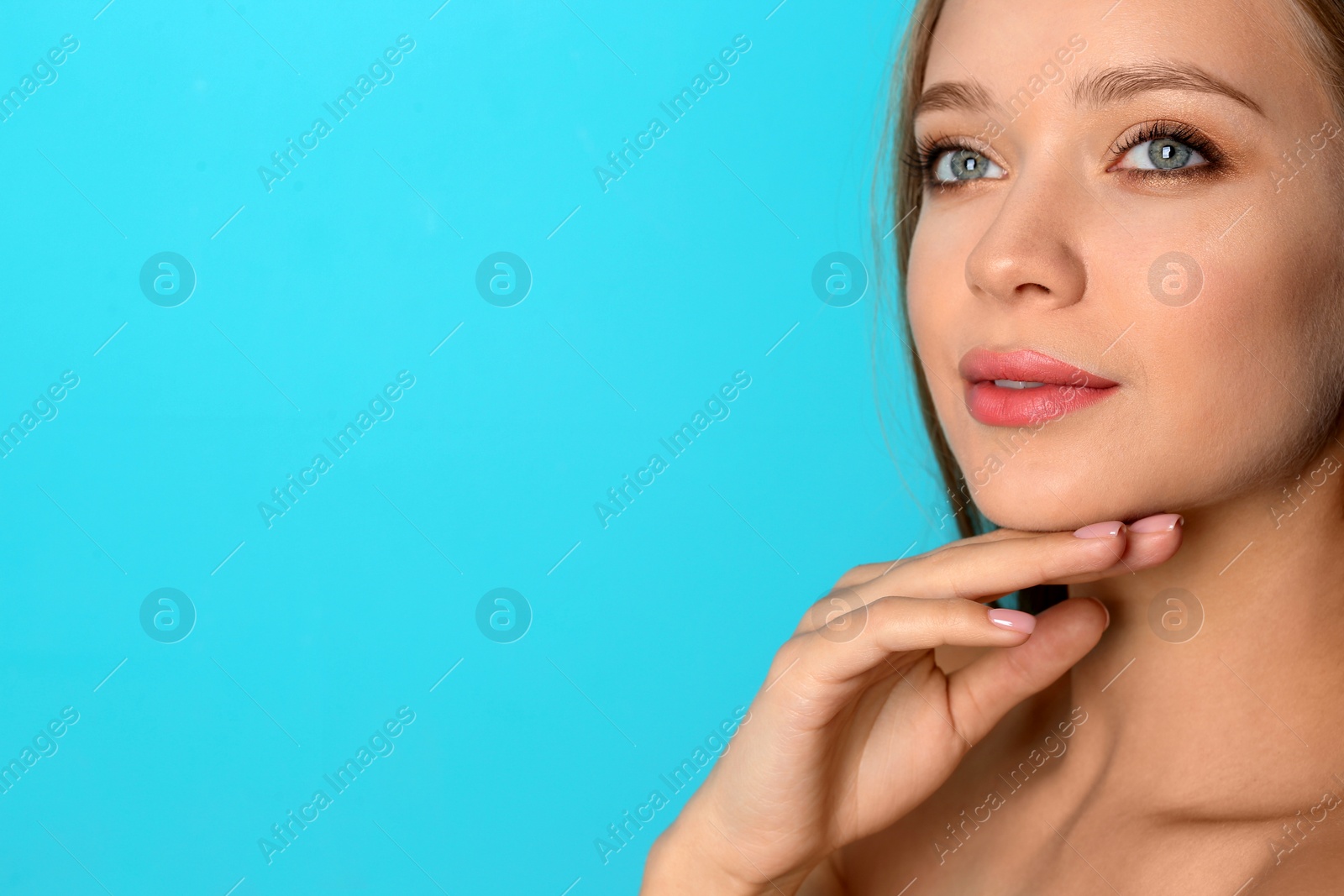 Photo of Portrait of beautiful young woman with natural makeup on color background. Space for text