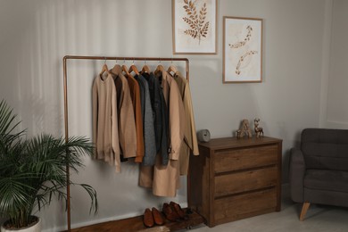 Modern dressing room interior with stylish clothes, shoes and decorative elements