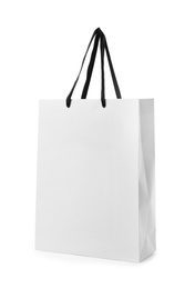 Photo of Paper shopping bag with handles on white background. Mockup for design