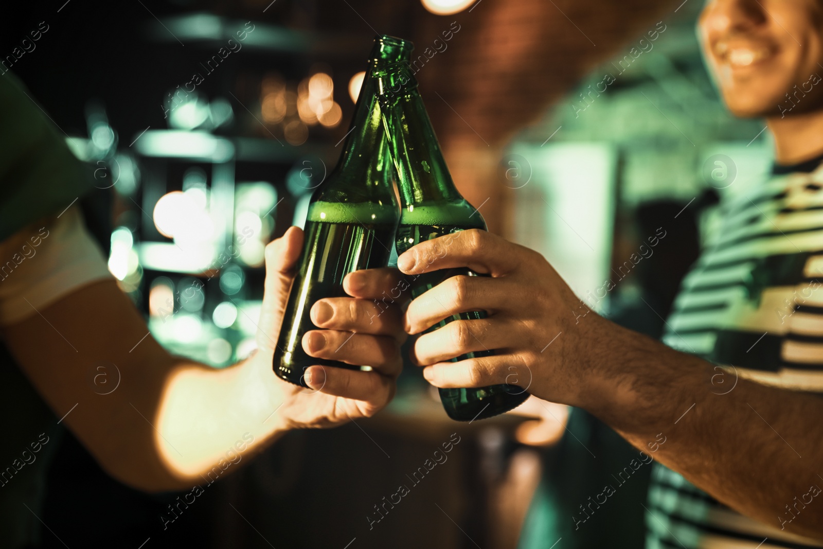 Photo of Men with beer celebrating St Patrick's day in pub, closeup