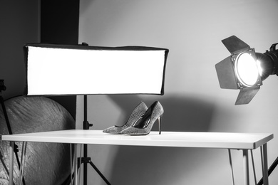 Photo of Professional photography equipment prepared for shooting stylish shoes in studio