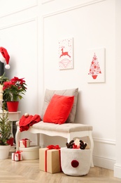 Photo of Christmas themed pictures in bright room with festive decorations. Interior design