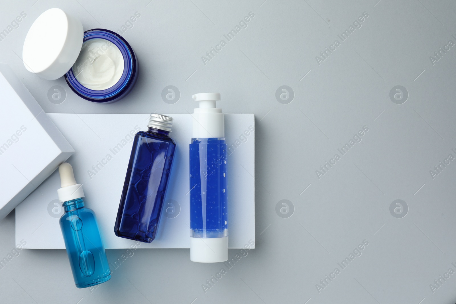 Photo of Set of cosmetic products on light grey background, flat lay. Space for text