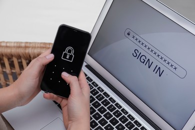 Photo of Woman unlocking smartphone with blocked screen near laptop indoors, closeup