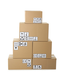 Stack of cardboard boxes with different packaging symbols on white background. Parcel delivery