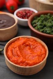 Photo of Fresh marinade in bowl on grey wooden table, closeup