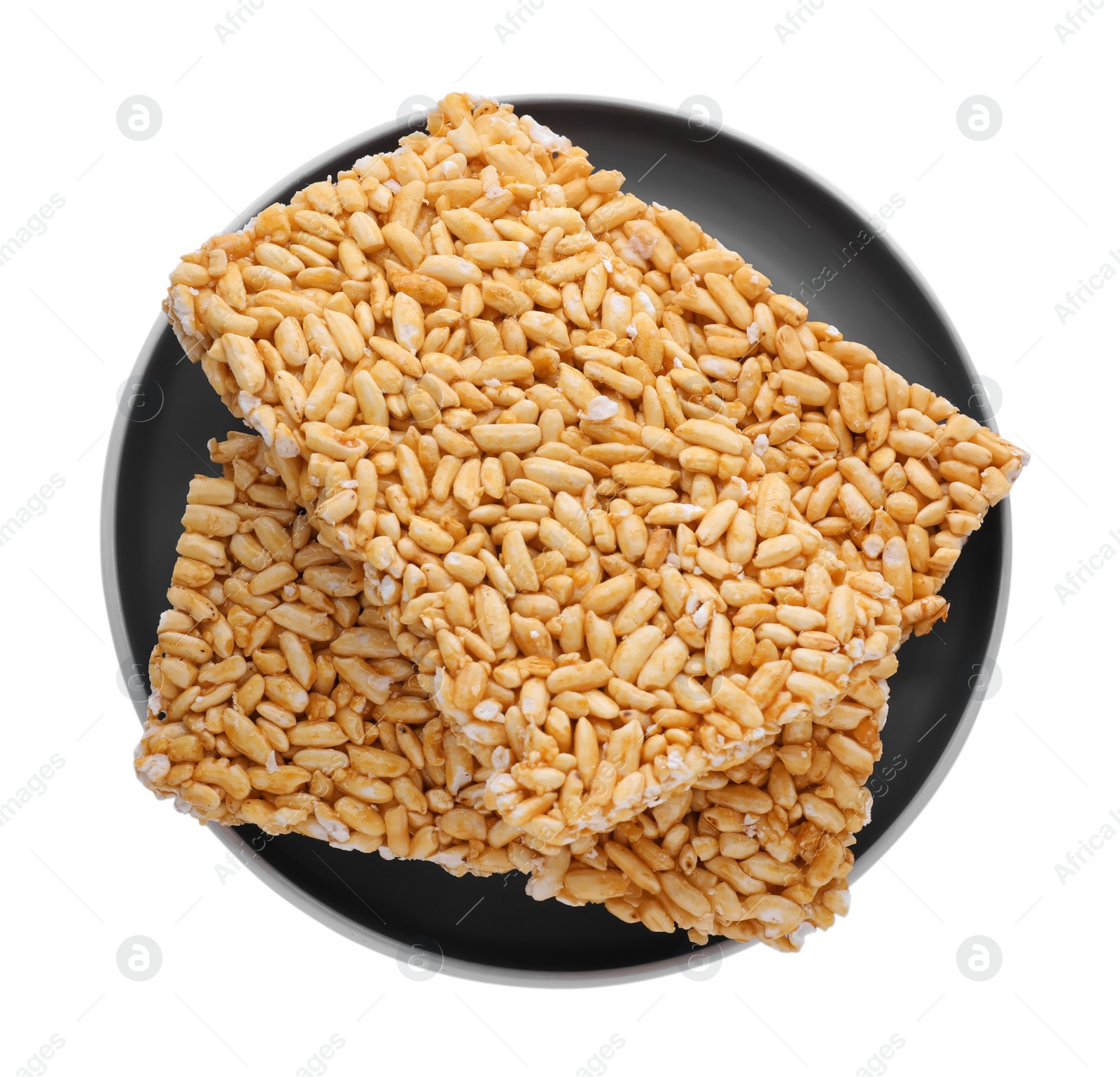 Photo of Plate with puffed rice bars (kozinaki) on white background, top view