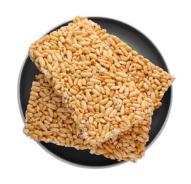 Photo of Plate with puffed rice bars (kozinaki) on white background, top view