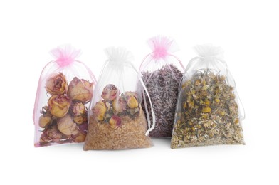 Scented sachets with dried flowers on white background