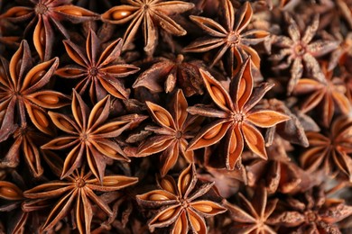 Photo of Aromatic anise stars as background, top view