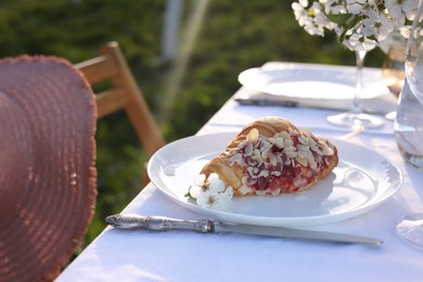 Stylish table setting with beautiful spring flowers in garden