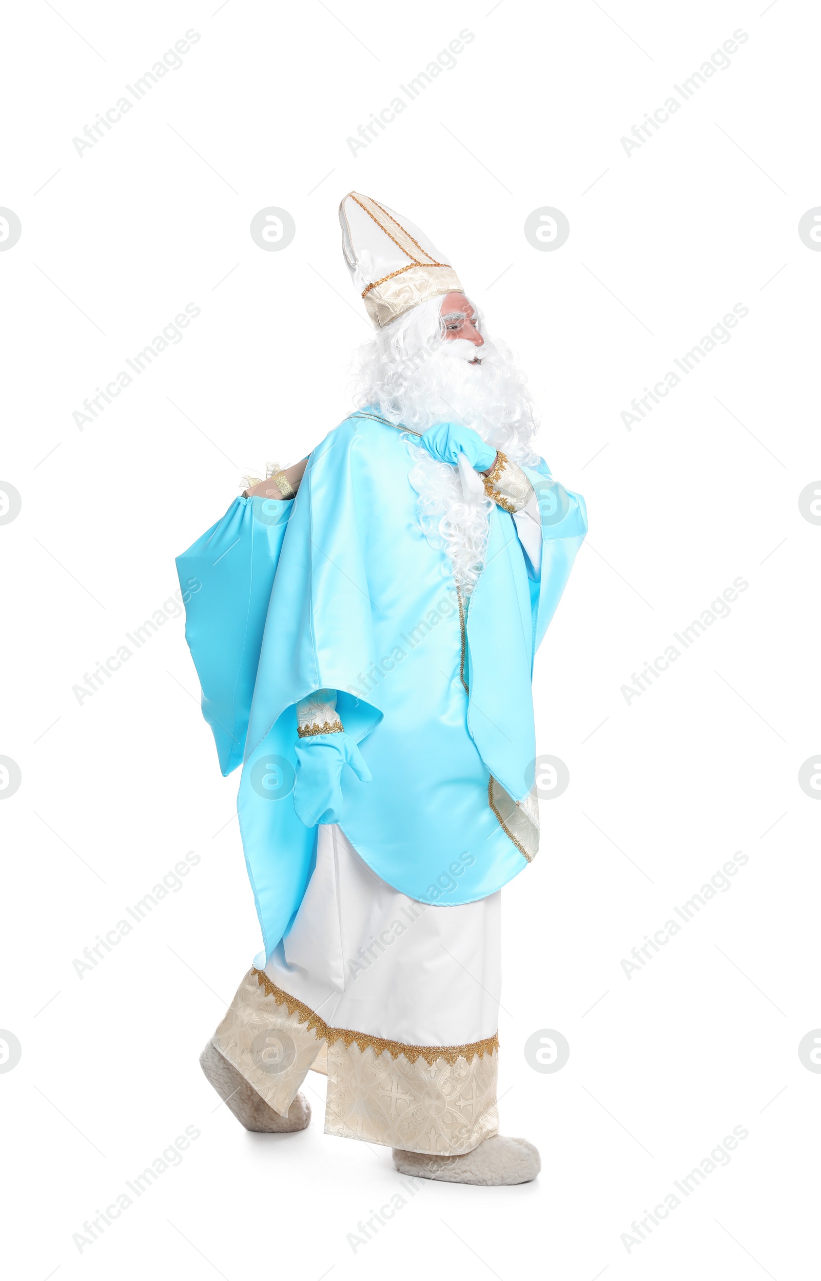 Photo of Full length portrait of Saint Nicholas holding sack with presents on white background