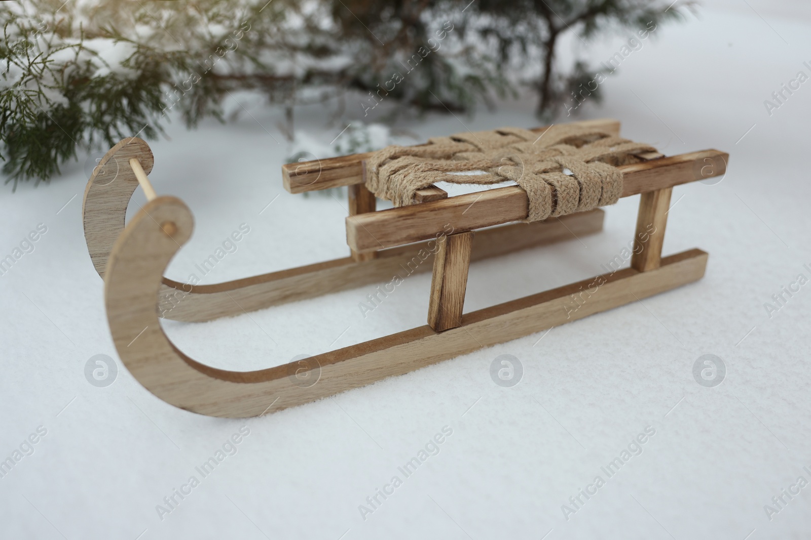 Photo of Beautiful decorative wooden sleigh on snow outdoors