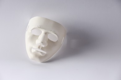 Plastic face mask on white background, space for text. Theatrical performance