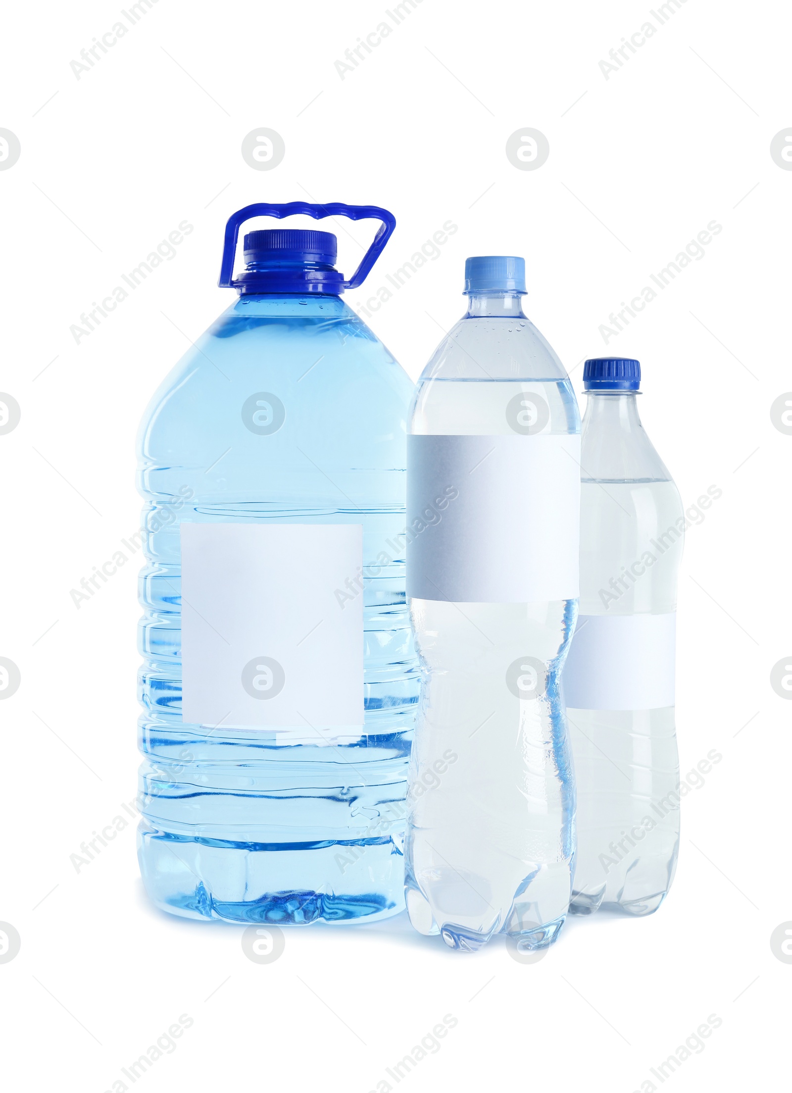 Photo of Different bottles of pure water with blank tags on white background