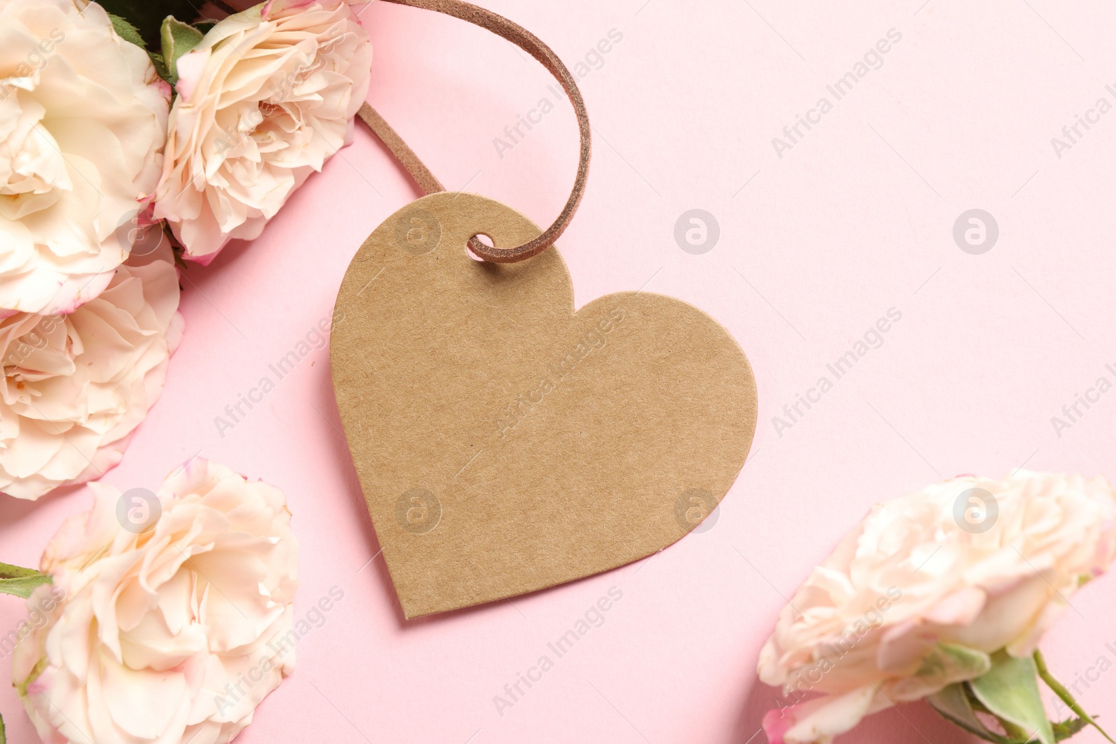 Photo of Happy Mother's Day. Beautiful flowers with blank heart shaped card on pink background