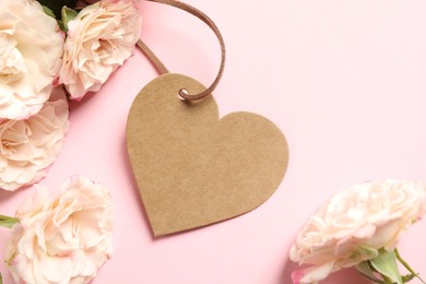 Photo of Happy Mother's Day. Beautiful flowers with blank heart shaped card on pink background