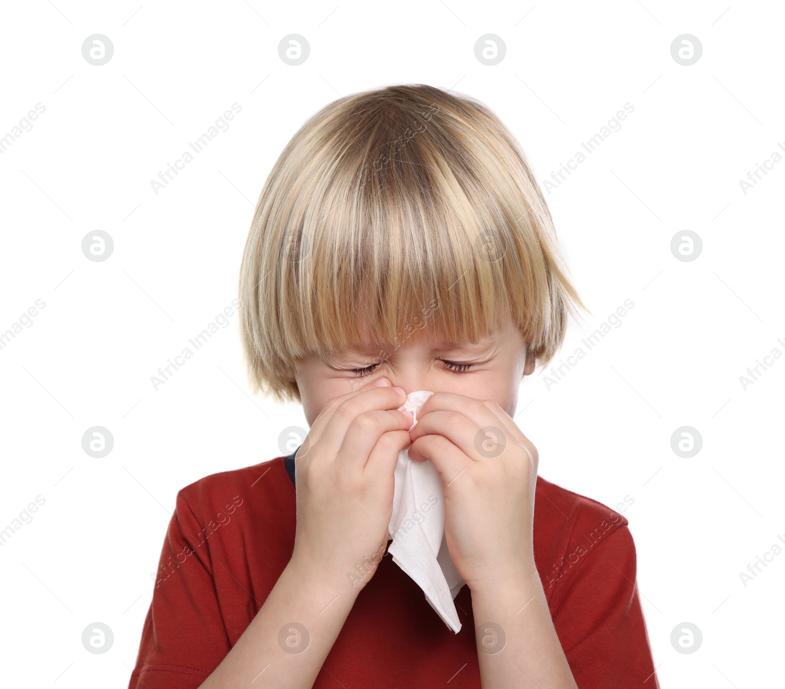 Photo of Boy blowing nose in tissue on white background. Cold symptoms