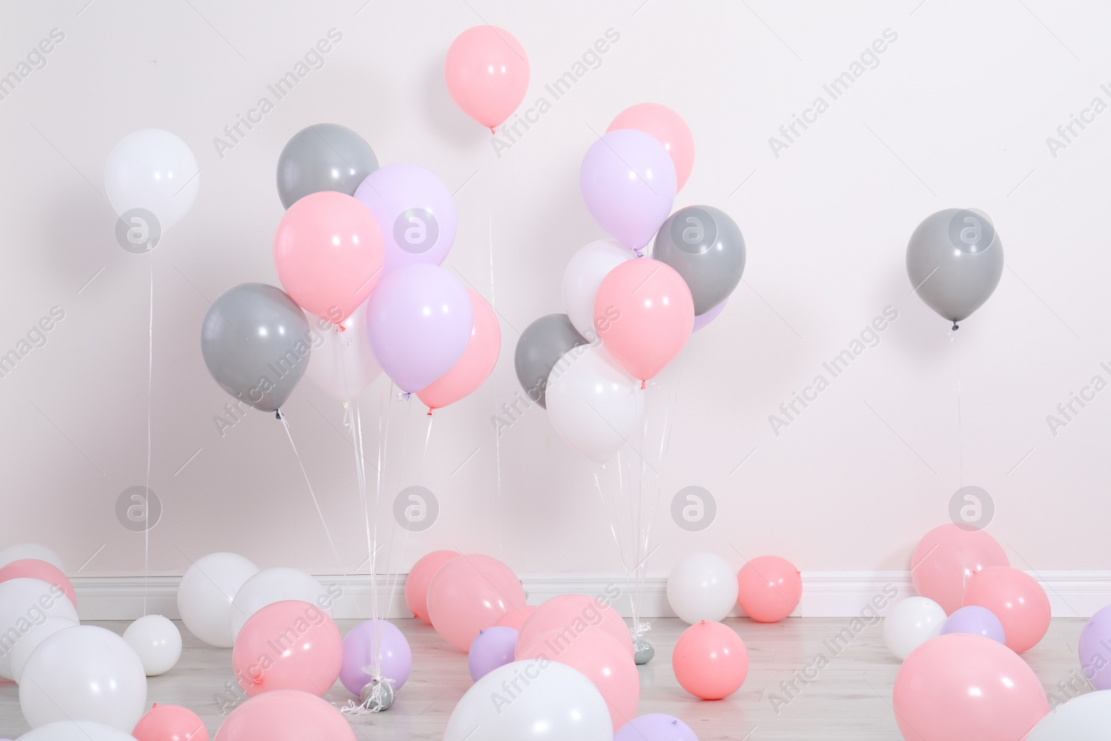 Photo of Room decorated with colorful balloons near wall