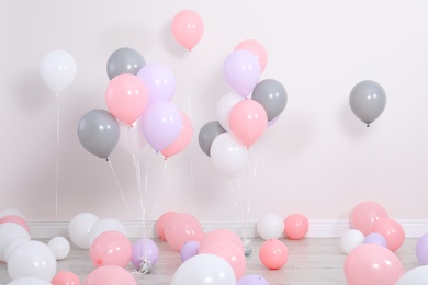 Photo of Room decorated with colorful balloons near wall