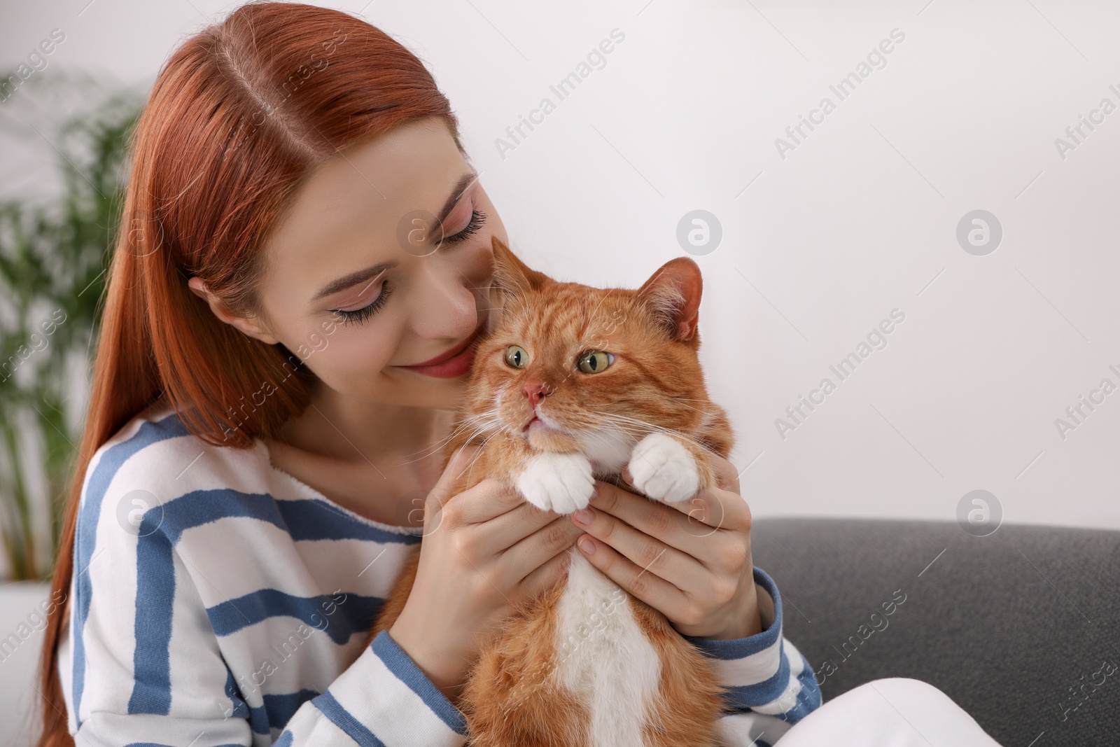 Photo of Woman with her cute cat at home